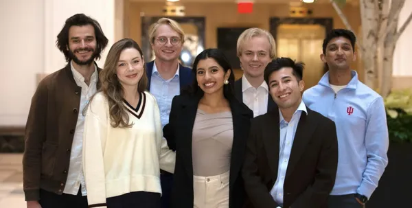 Group photo of seven young professionals in business casual attire